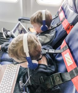 Tips for flying with toddlers. Toddlers wearing FAA approved harness on airplane