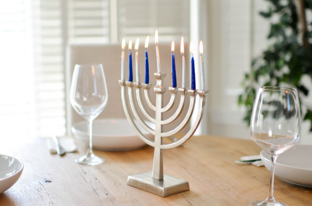 a menorah on a tabletop with blue and white candles, for those who don’t celebrate Christmas