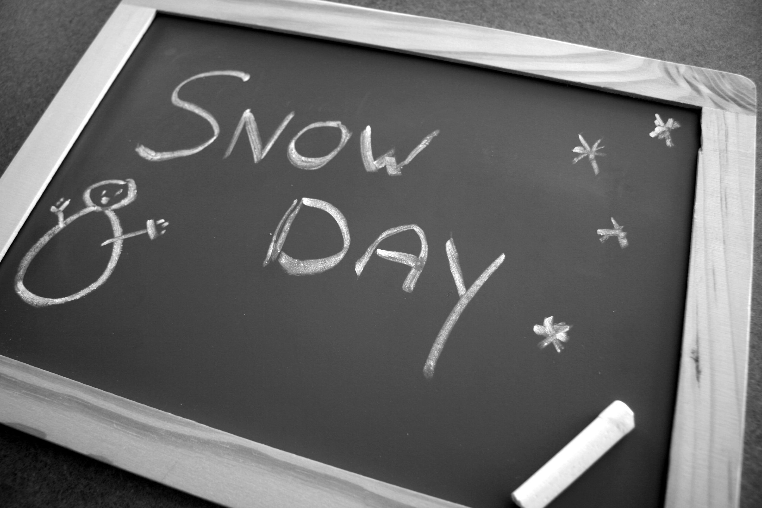 Snow Day written on chalkboard with drawing of snowman