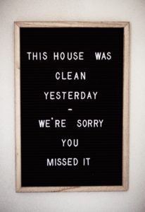Black letter board with a spring cleaning quote, "This house was clean yesterday, we're sorry you missed it."