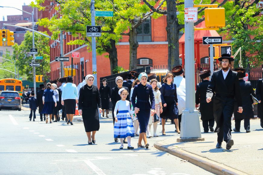 a Jewish neighborhood where people are walking to temple on Sabbath