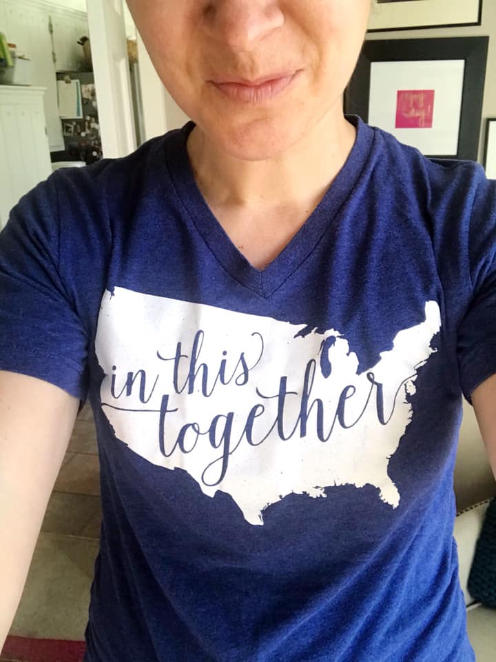 In this together t-shirt with blue writing on a white outline of the united states