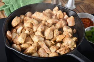 Diced chicken in a cast iron skillet