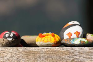 Painted rocks on a wooden table