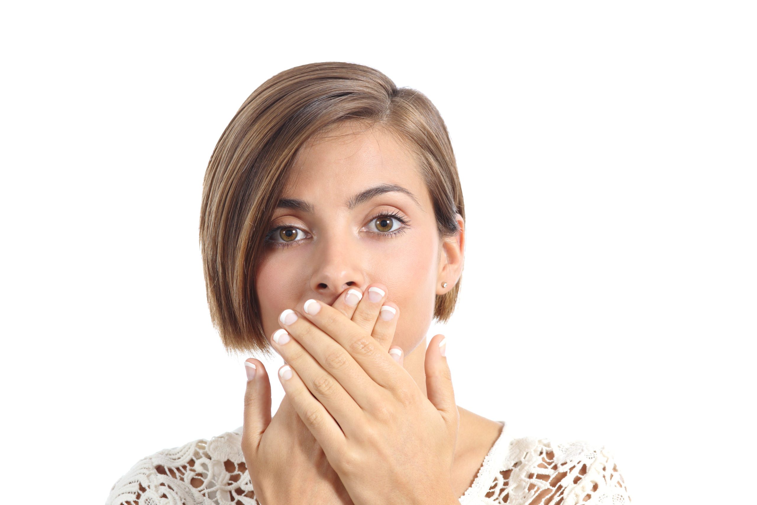 woman covering her mouth because of a cold sore
