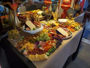 charcuterie spread of fruits, cheeses, crackers, and meats on a table