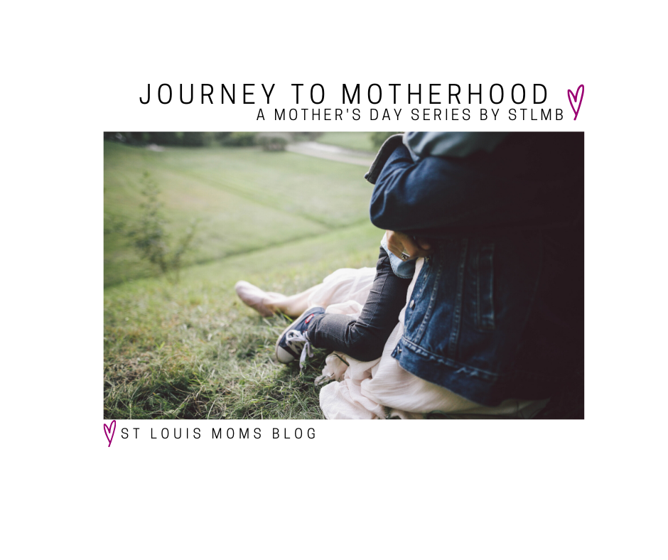 a close up photo of a child wrapped in her mother's arms as they sit on a grassy hill with the words, "Journey to Motherhood, A Mother's Day Series by STLMB, St. Louis Moms Blog on it