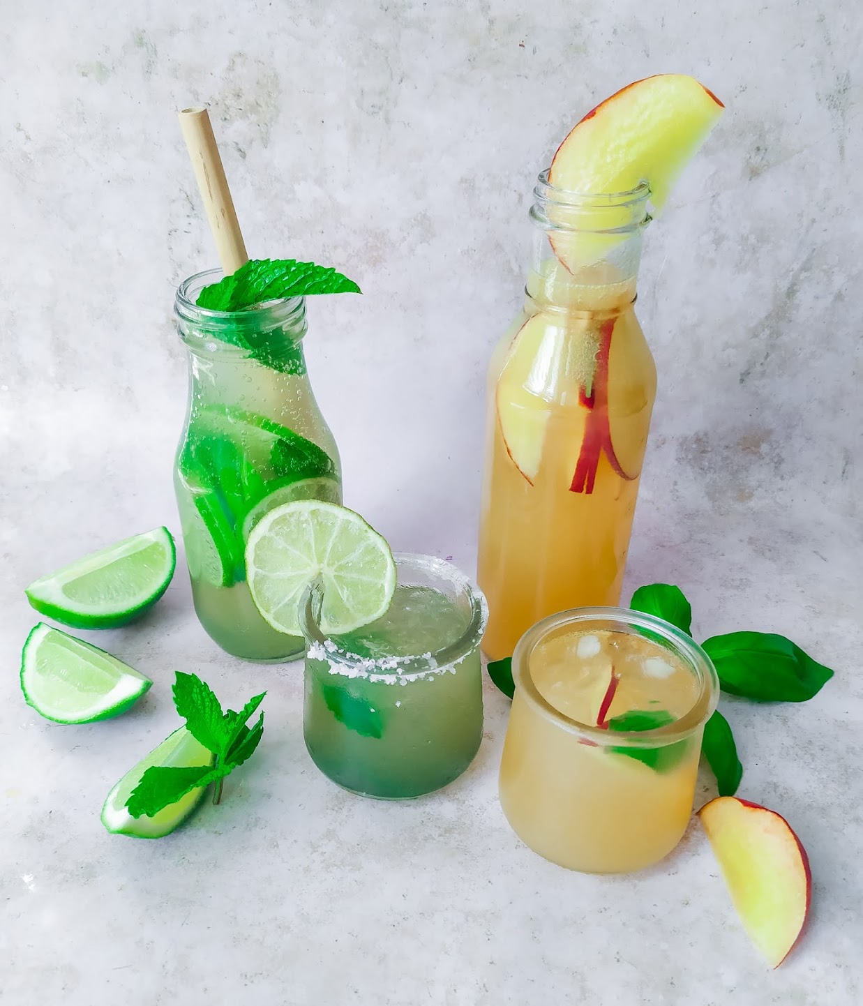 fruity mocktails made from limes and peaches on a white background