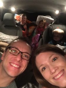 family selfie inside of packed minivan