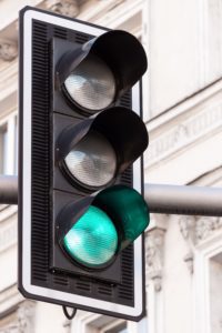 A traffic light with the green light lit