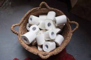 Toilet paper rolls in a basket.