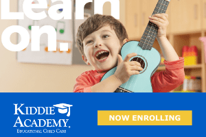 a photo of a child strumming a ukulele for Kiddie Academy