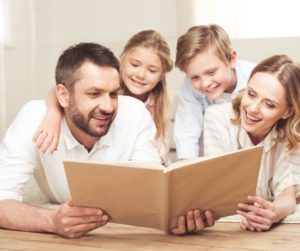 a family reading a book together 