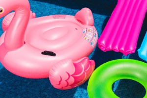 pool floats and an inflatable flamingo in a swimming pool