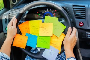 a steering wheel covered with post it notes