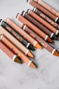 different skin tone coloured crayons on a tabletop which can help with talking about race to our children
