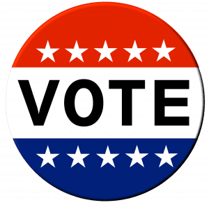a circular patch with a red, white, and blue stripe with the word VOTE across the middle in black
