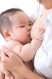 an Asian baby boy breastfeeding