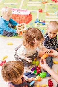 babies and toddlers playing together in daycare