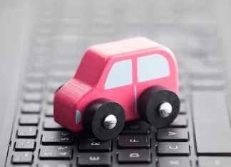 a toy car on a laptop keyboard