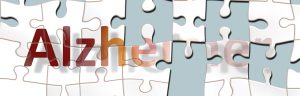 the word Alzheimers on white puzzle pieces, where half of the pieces are missing