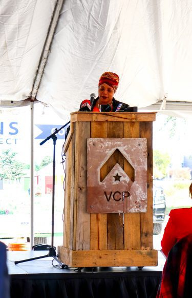 a Senator standing at a podium, dedicating land for the Veterans Community Project