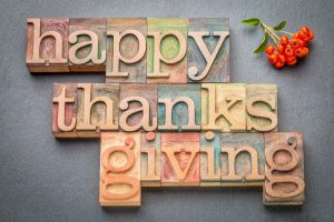 happy thanksgiving written on different colored wooden blocks
