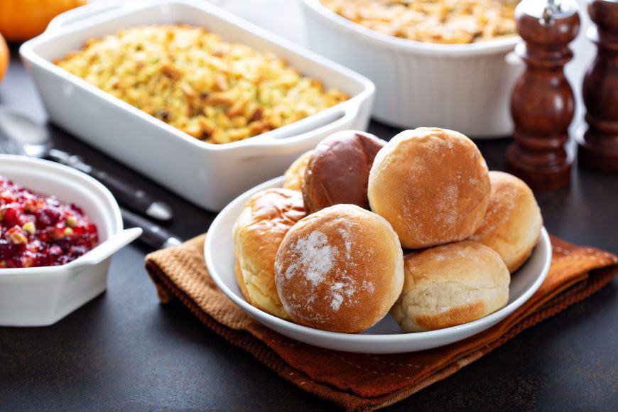 a close up of dinner rolls and cranberry sauce