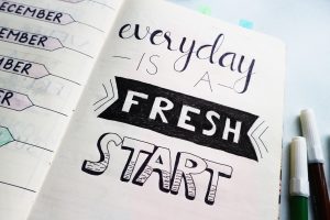a planner with the quote, "everyday is a fresh start" to remind you to live intentionally