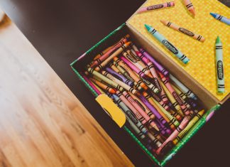 a box of crayons open on a tabletop