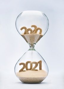 an hourglass full of sand with 2020 on the top and 2021 on the bottom