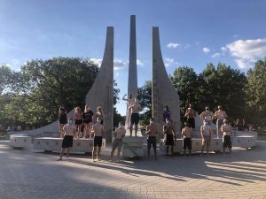 a group of college students gathered in front of a fountain on Purdue's campus