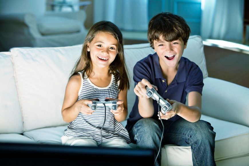 a boy and a girl on the couch playing video games