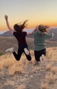 two girls jumping up in the air