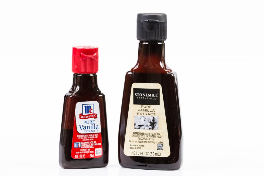 two bottles of vanilla extract on a white background