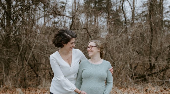 A woman hugging a pregnant woman who is carrying the baby via surrogacy