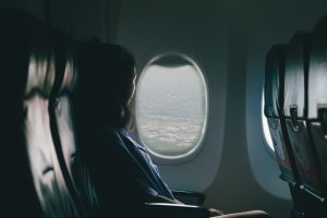 a woman on an empty plane sitting by the window