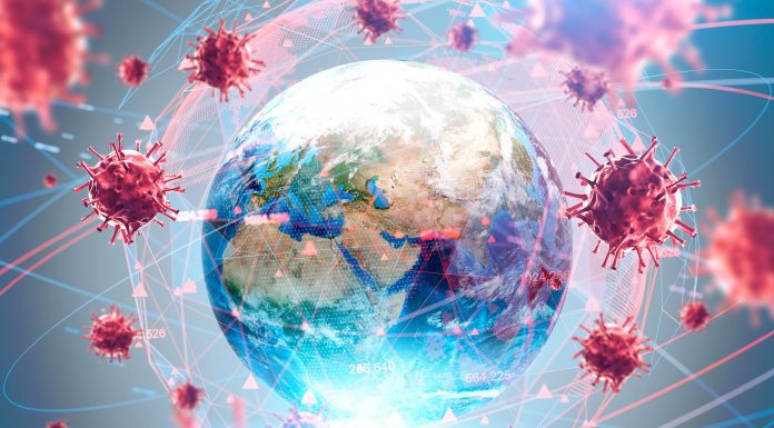 a globe surrounded by the coronavirus conveying the worldwide pandemic