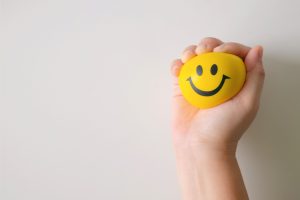 a yellow stress ball with a smiley face