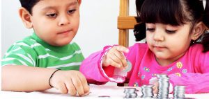 a boy and a girl stacking up coins as they count their money