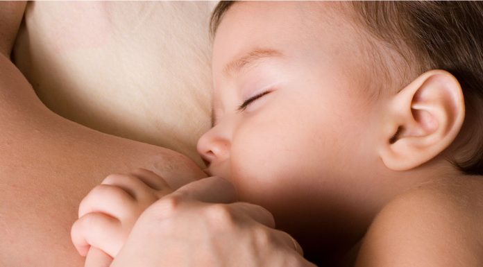 a baby boy breastfeeding on his mom's chest