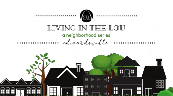 a black and white drawing of homes in a neighborhood with green trees in the background and a banner above saying, “Living in the Lou, a Neighborhood Series: Edwardsville"
