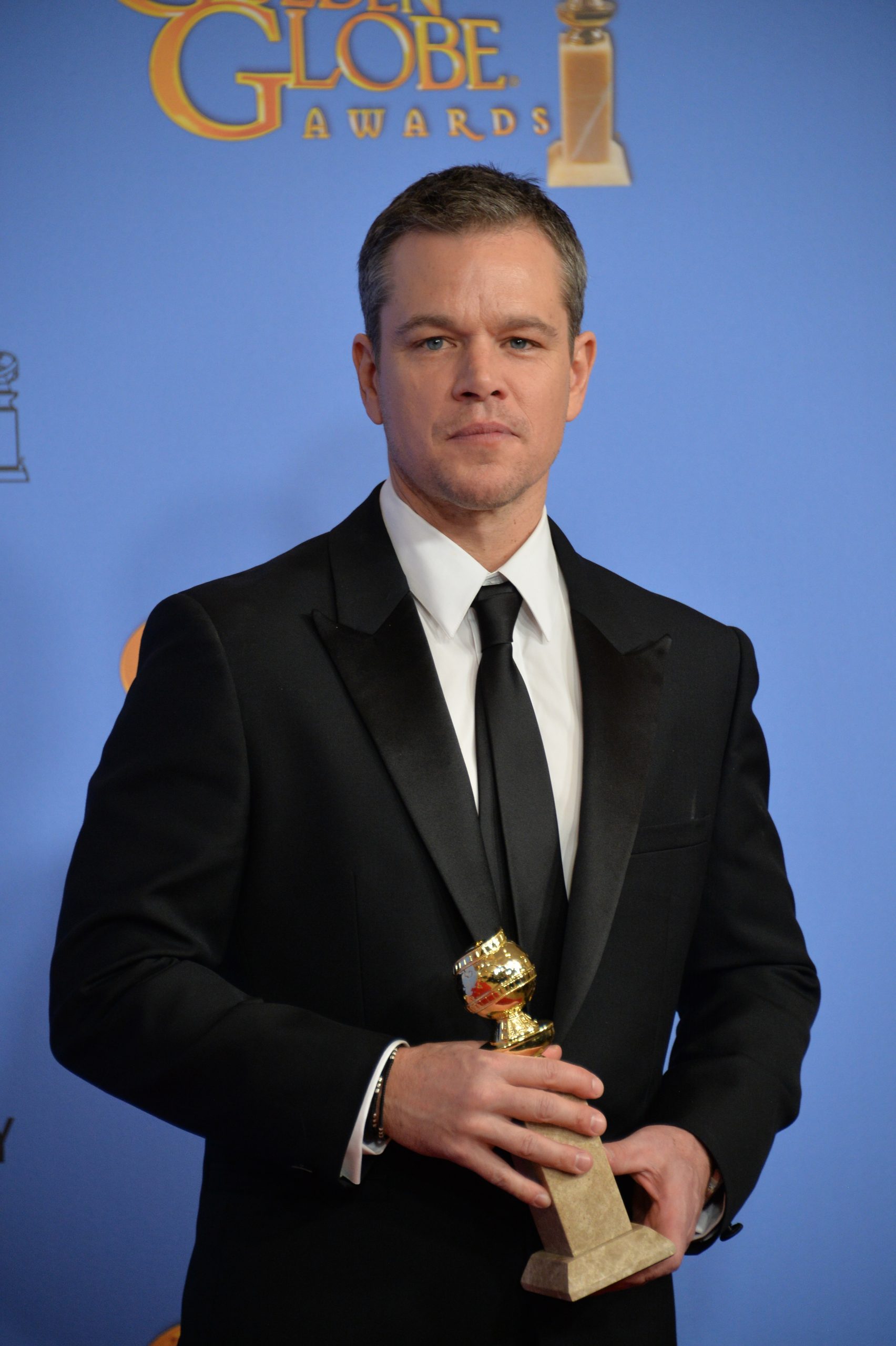 Matt Damon holding a Golden Globe