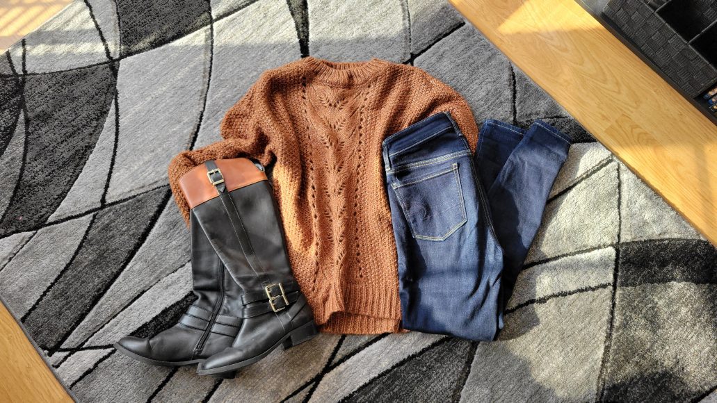 Leather boots, a chunky sweater, and dark wash jeans for fall