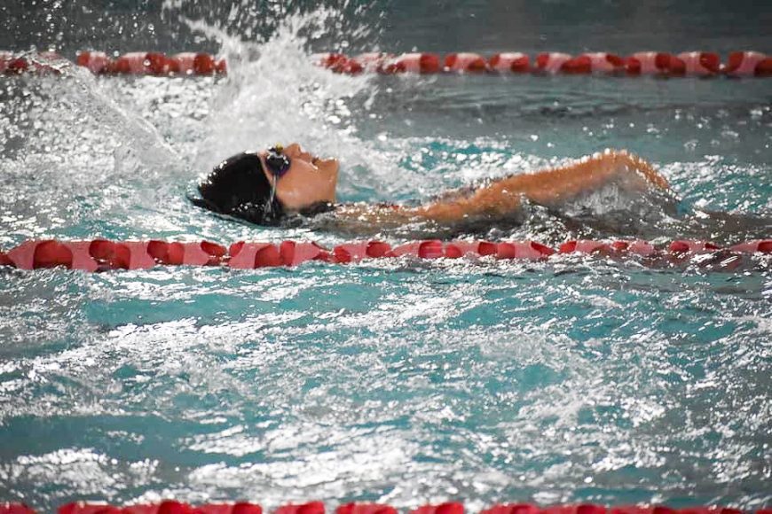 a girl swimming in a race