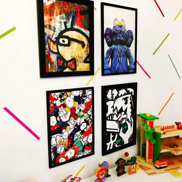 a brightly colored wall of art by favorite artists for kids’ spaces
