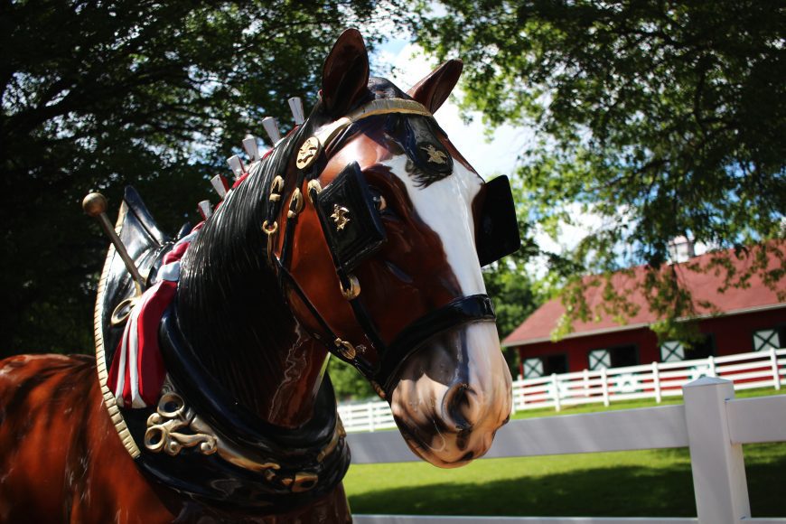 a statue of a Clydesdale in front of a historic building at Grant’s Farm in St. Louis, Missouri