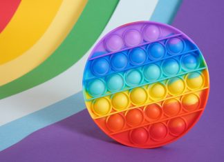 a rainbow striped pop-it toy used to help kids calm down