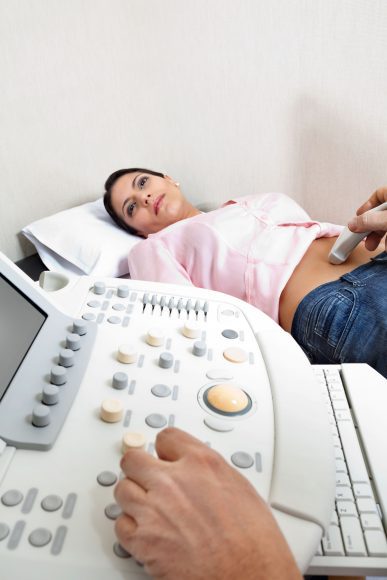 a woman getting an ultrasound to confirm a pregnancy