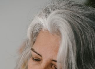 a woman with grey hair looking over her shoulder